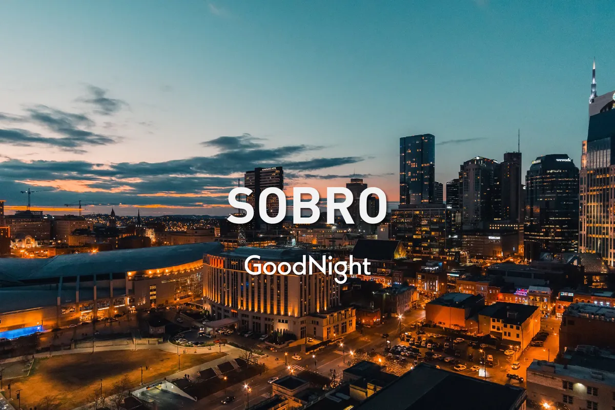 The image captures the Nashville city skyline at sunset, with street lights illuminating the scene and hints of nightlife beginning to emerge. It suggests opportunities for nighttime exploration, dining, and discovering the vibrant city after dark.